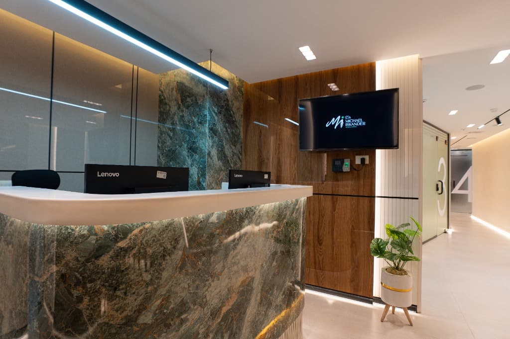 Executive Reception Desk with TV and clinic hallway